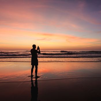 Silhouette of tourist at sunset beach in Phuket Thailand