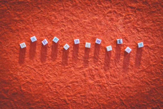 Happy New Year written in letter beads on mulberry paper background