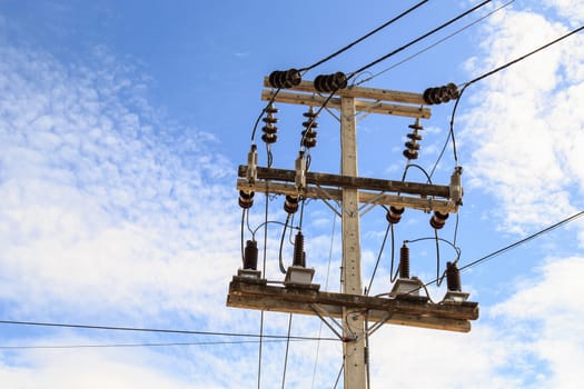 Electric pole power lines and wires with blue sky background