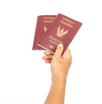 Hand holding Thailand passport isolated on white background