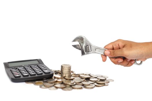 Stack of coin with hand holding wrench in concept repair money problem isolated on white background