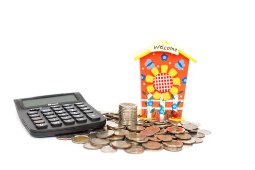 piggy bank with stack of coin and calculator isolated on white background