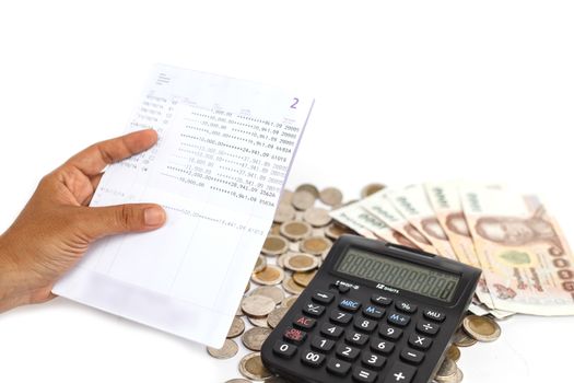 Hand holding book bank and stack of money in consept checking money in the account isolated on white background