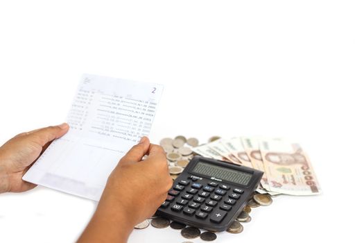 Hand holding book bank and stack of money in consept checking money in the account isolated on white background