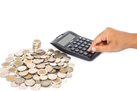 Hand pressing calculator and stack of coin isolated on white background