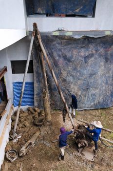 Workers drilling for a foundation pile in construction site