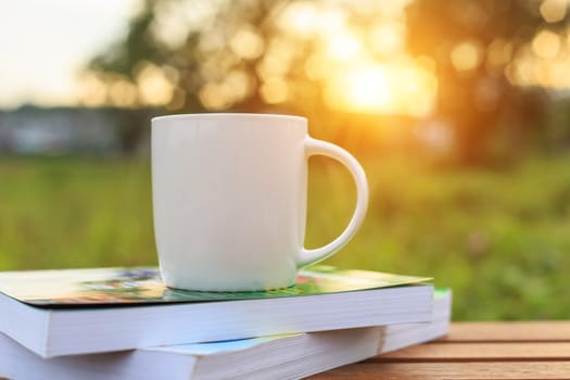 Coffee cup and book on the table in the morning