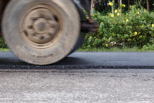 Road roller and asphalt paving machine at construction site