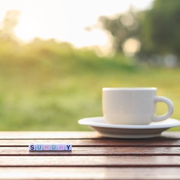 Sunday written in letter beads and a coffee cup on table