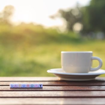 Saturday written in letter beads and a coffee cup on table