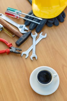 Close up coffee cup and assorted work tools on table