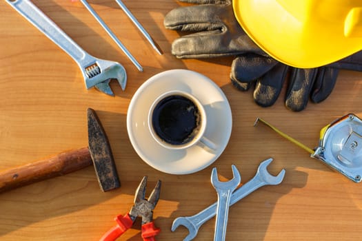 Close up coffee cup and assorted work tools on table