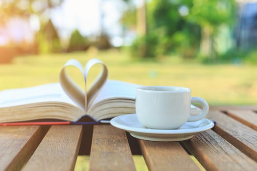 Coffee cup and book on the table in the morning