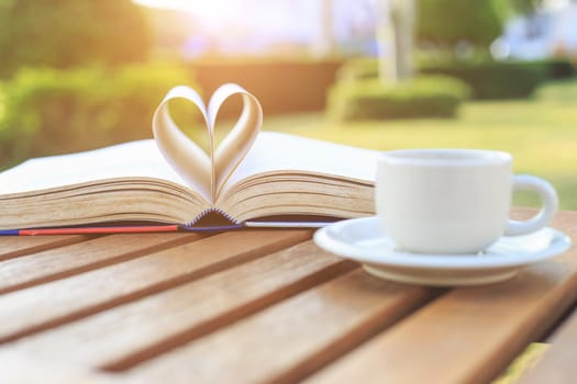 Coffee cup and book on the table in the morning