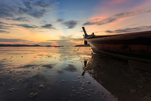 Silhouettes of longtail boat and sunrise in Phuket, Thailand