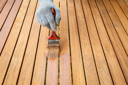 Brush in hand and painting on the wooden table