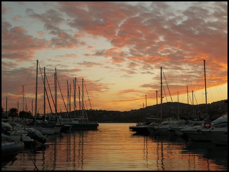 Sunset over docked boats at Sainte Maxime's port