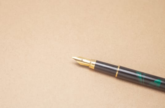 Vintage Fountain Pen on old paper background

