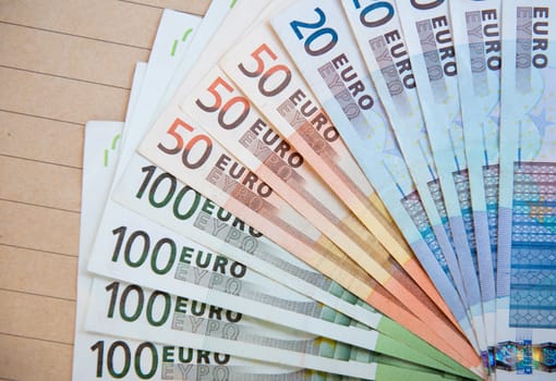 euro banknotes on brown envelope