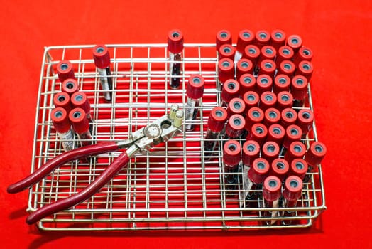 Rack of tubes with blood samples, laboratory microscope and laboratory