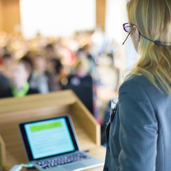 Female speaker at Business Conference and Presentation. Audience at the conference hall. Business and Entrepreneurship. Business woman.