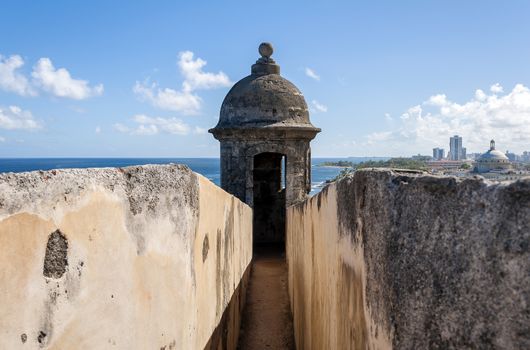Observation tower at the Castillo de San Cristobal, with Capitol building in the background, San Juan, Puerto Rico.