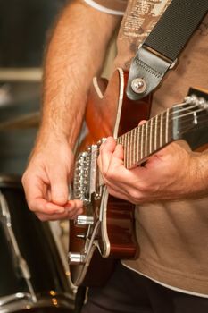 musician playing electric guitar during a live performance