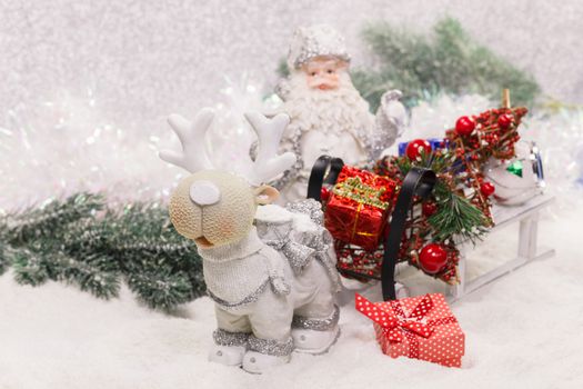 Santa Claus, Reindeer and sleigh with presents for Christmas decoration. A macro photograph with shallow depth of field