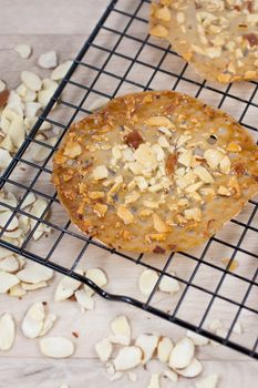 Almond lace cookies on a cooling rack.