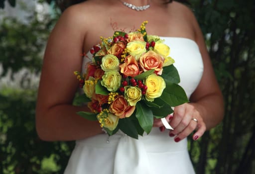 The bride holds a wedding bouquet