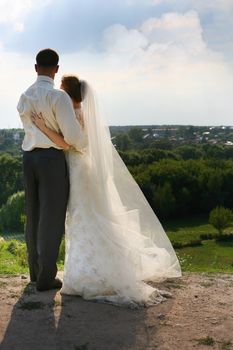 Beautiful the bride and groom on landscape background