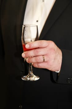 Glasses of champagne in a hand of the groom