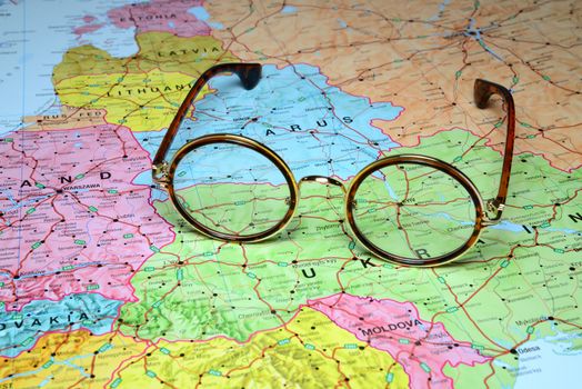 Photo of glasses on a map of europe. Focus on Kyiv, Ukraine. May be used as illustration for traveling theme.