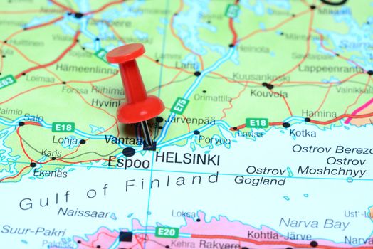 Photo of pinned Helsinki on a map of europe. May be used as illustration for traveling theme.