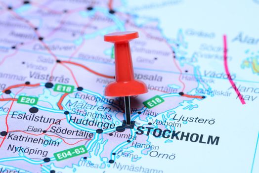 Photo of pinned Stockholm on a map of europe. May be used as illustration for traveling theme.