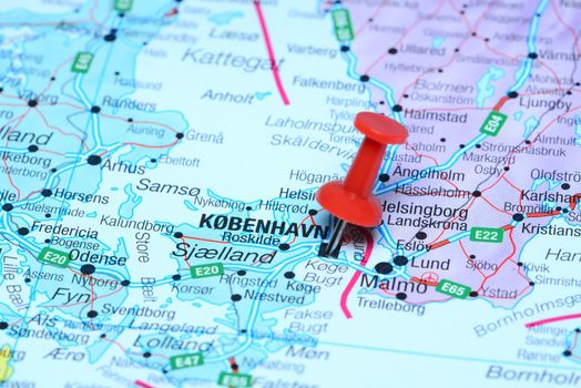 Photo of pinned Copenhagen on a map of europe. May be used as illustration for traveling theme.