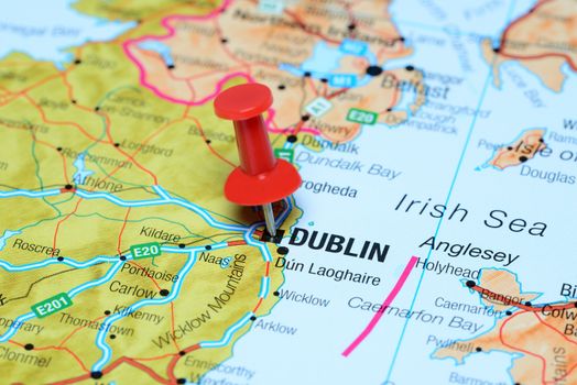 Photo of pinned Dublin on a map of europe. May be used as illustration for traveling theme.