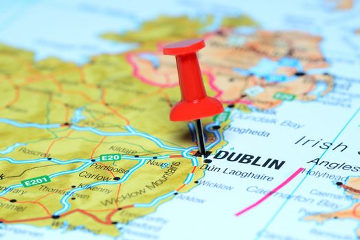 Photo of pinned Dublin on a map of europe. May be used as illustration for traveling theme.