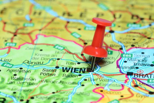 Photo of pinned Vienna on a map of europe. May be used as illustration for traveling theme.