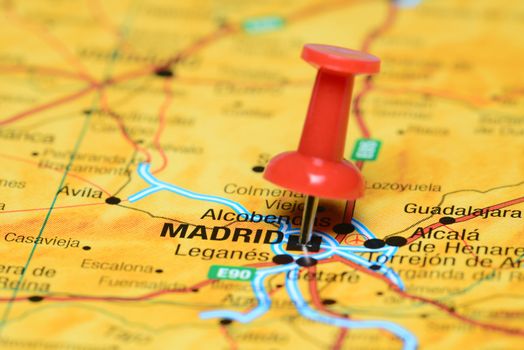 Photo of pinned Madrid on a map of europe. May be used as illustration for traveling theme.