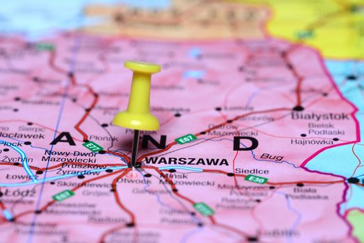 Photo of pinned Warsaw on a map of europe. May be used as illustration for traveling theme.