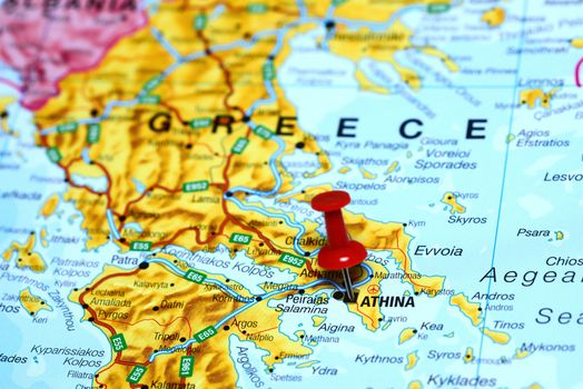 Photo of pinned Athens on a map of europe. May be used as illustration for traveling theme.