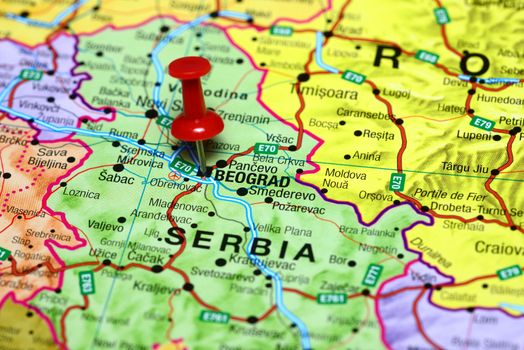 Photo of pinned Belgrade on a map of europe. May be used as illustration for traveling theme.