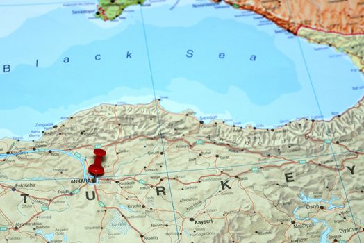 Photo of pinned Ankara on a map of europe. May be used as illustration for traveling theme.