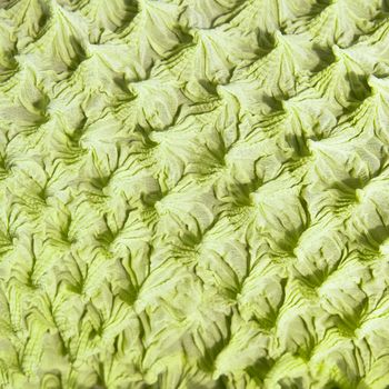 Part of a textured green fabric as a background