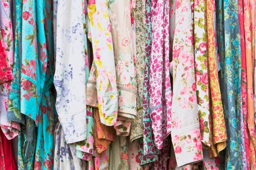 Floral patterned vintage dresses at a market