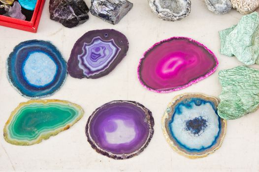 Colorful stones on display on a white surface