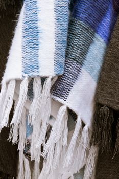 Fringe tassels of a blue and white wool blanket