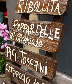 Typical Tuscan menu for tourists on the street exposed to attirere attention