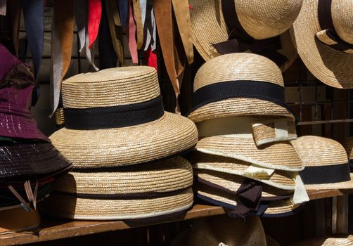 Stack of straw hats to keep cool in summer